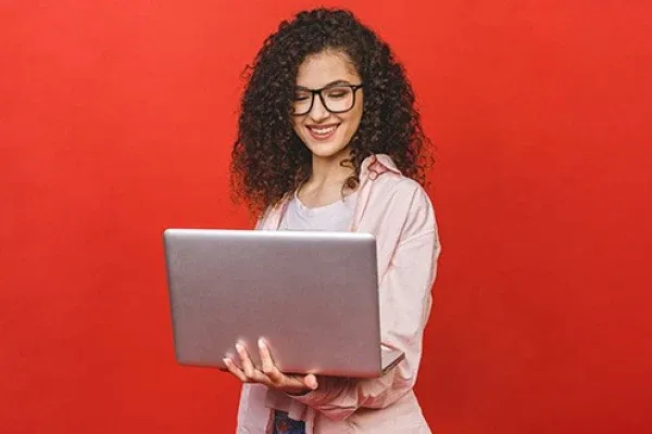 smiling woman with laptop red background